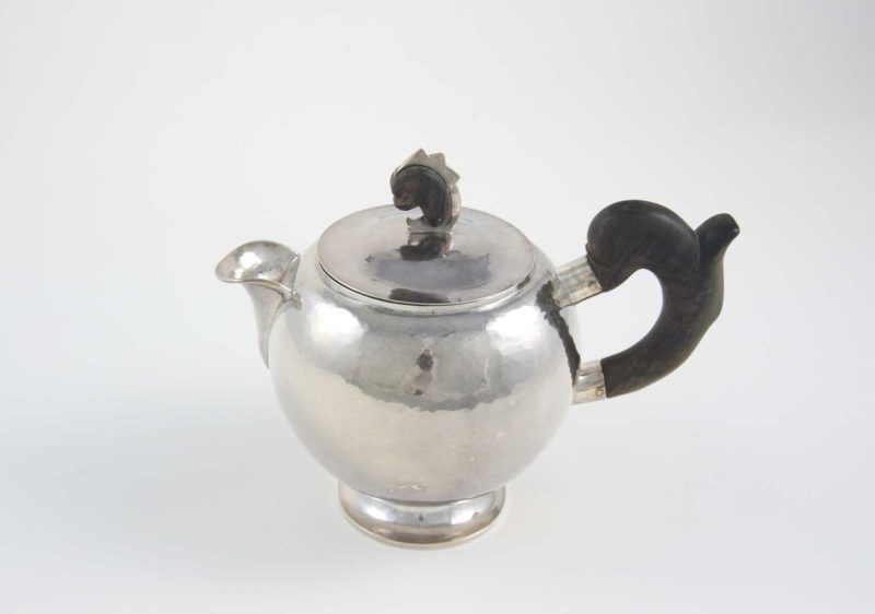 William Waldo Dodge Jr. and Johnny Green, Teapot, circa 1928, hammered silver and ebony wood, 8 × 5 ¾ × 9 ½ inches . Gift of William Waldo Dodge III, 2005.26.03.59. © Estate of William Waldo Dodge Jr.