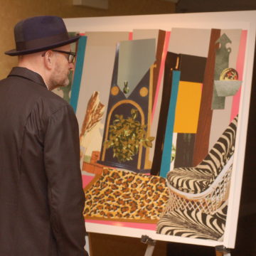 A collectors circle member views art.