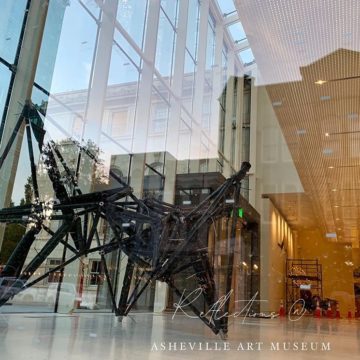 @dianestravelheart Decided to create my own “artwork” by looking in window from the outside at @ashevilleartmuseum which opens later this summer! The metal sculpture is by contemporary sculptor Kenneth Snelson. Who knew reflections could be so interesting?! ??Waiting patiently to see the real thing!??